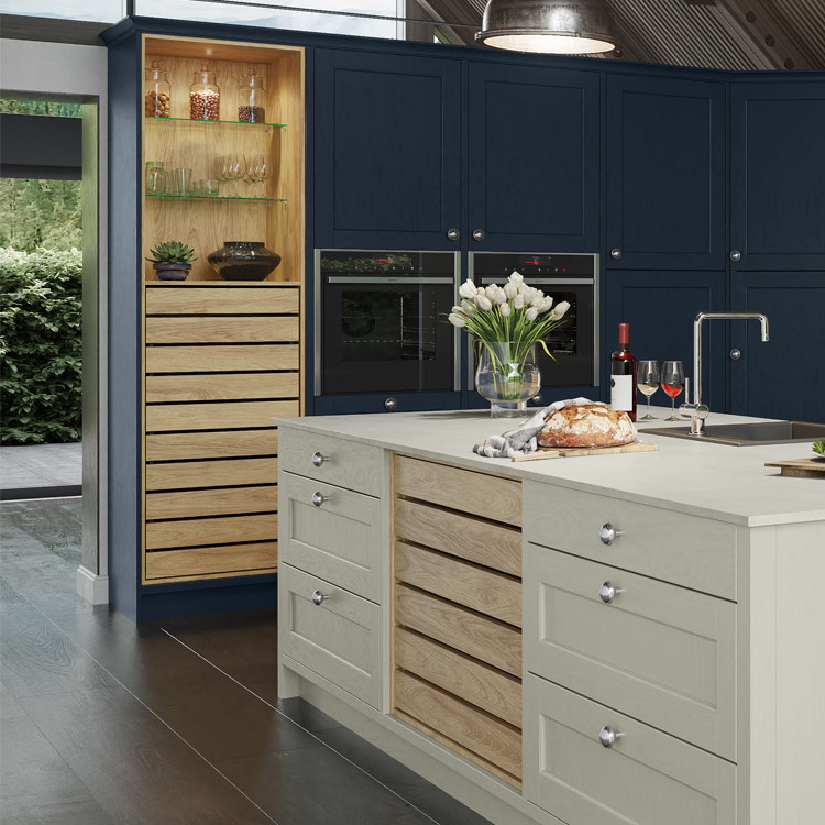 Wodd crate drawers in a grey kitchen island an a dark blue larder unit