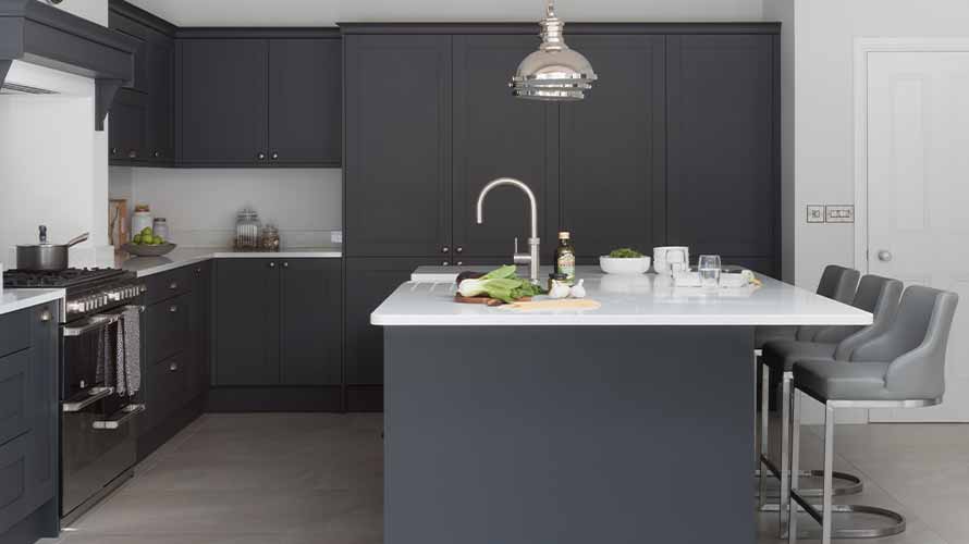 Dark grey shaker kitchen featuring kitchen island and mantle