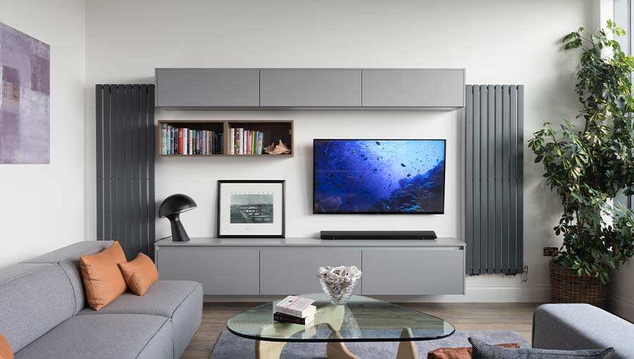 A modern open plan living space featuring handleless units