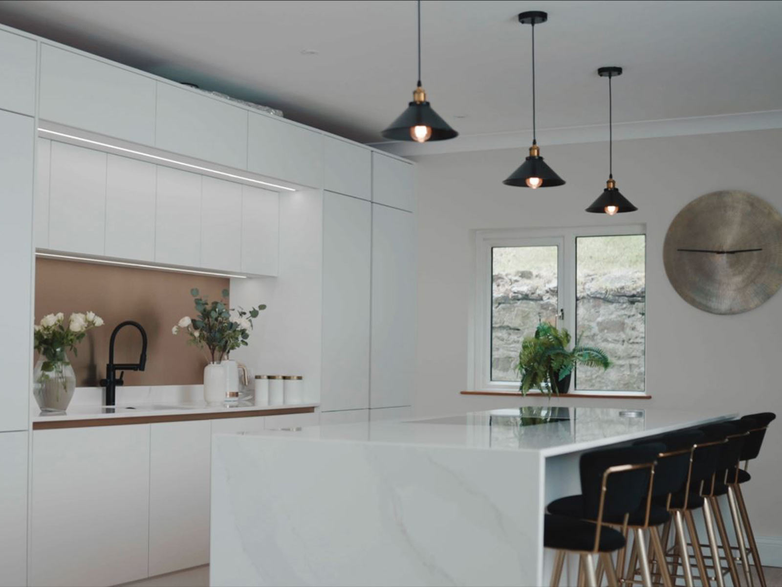 Large white gloss kitchen island and matching kitchen wall units