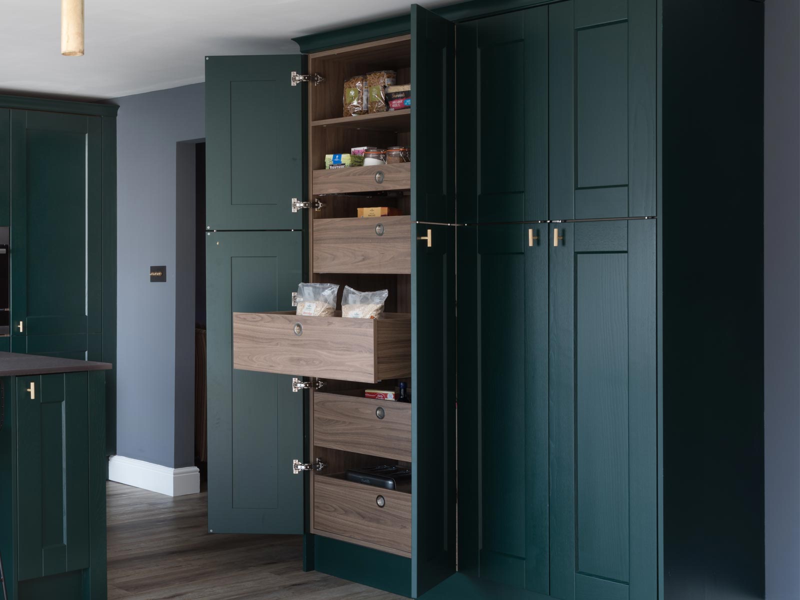 A kitchen storage cabinet with pull-out cabinet kitchen drawers