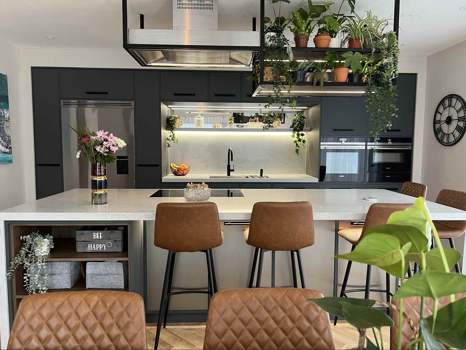 A biophilic kitchen with decorative stone worktops and wood walnut shelves