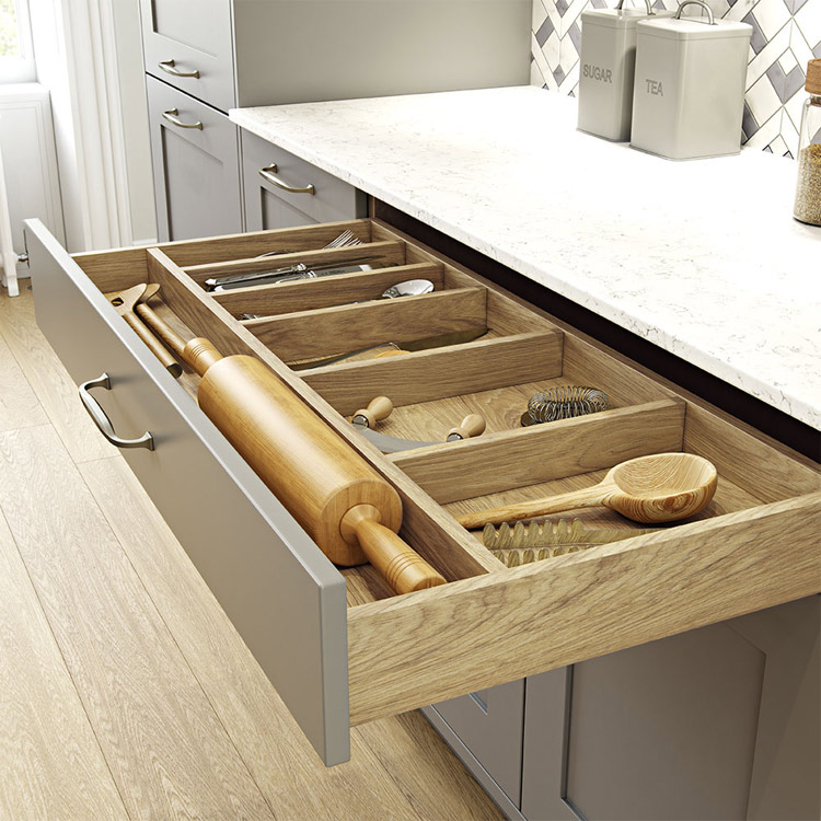 Light wood kitchen drawer interior shown with modern kitchen drawer front