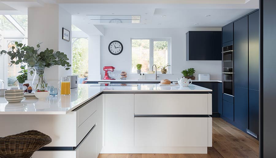 Blue handleless kitchen with white kitchen island