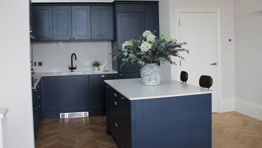 Blue shaker kitchen featuring blue kitchen island