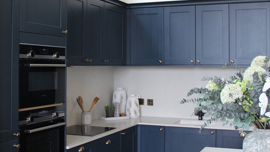 Blue kitchen featuring cup and knob handles