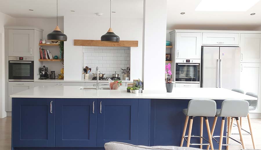 Large blue kitchen island in a shaker kitchen