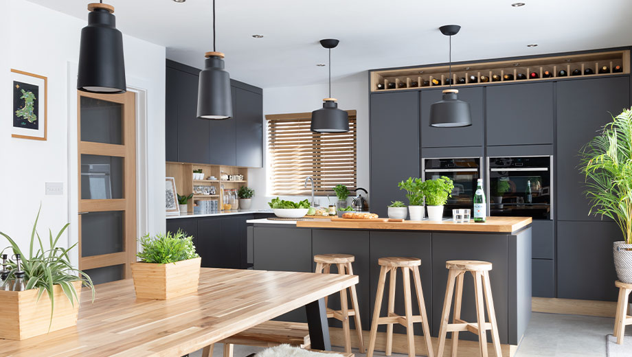 Dark modern kitchen with plants and wood shelving