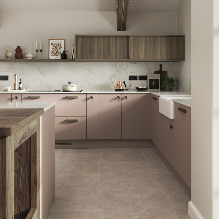 A pink painted kitchen with dusty pink cabinets and dark wood wall cabinets