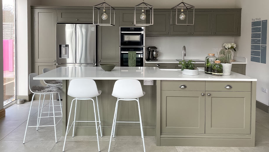 Olive green kitchen featuring island