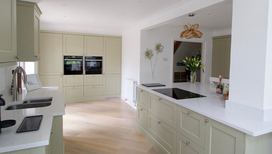 Bright, light green kitchen by Kingswell Kitchens