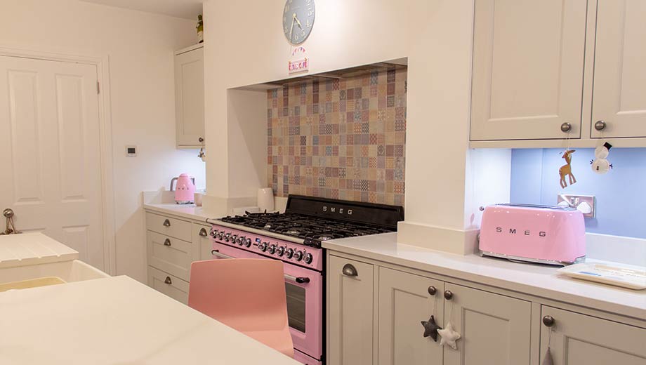 Grey shaker kitchen with pink accents