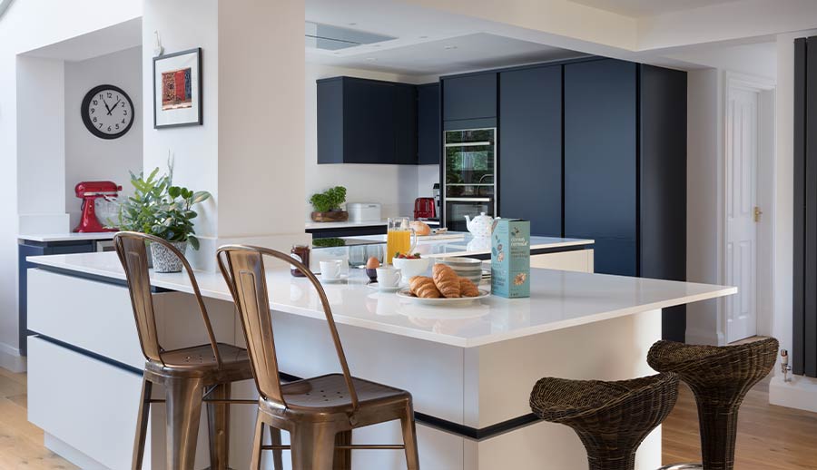 Large kitchen island in a blue handleless kitchen