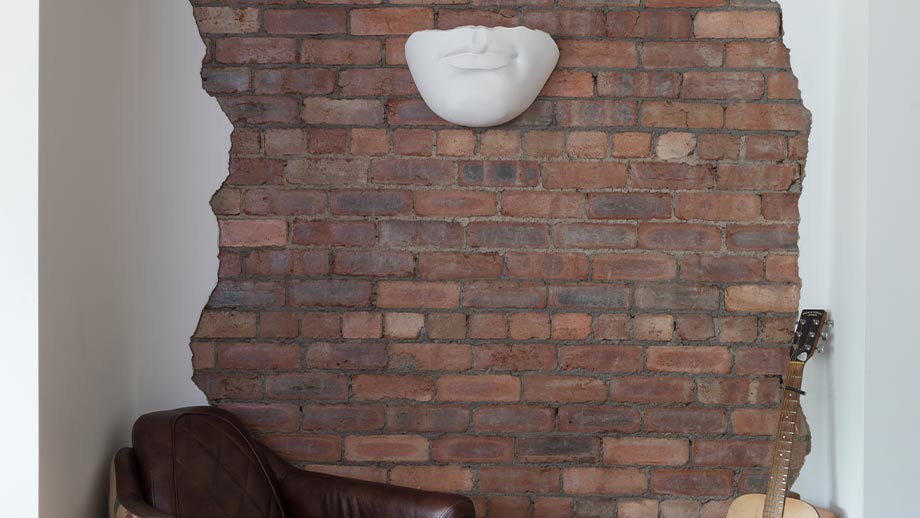 Exposed brick wall in an industrial style kitchen