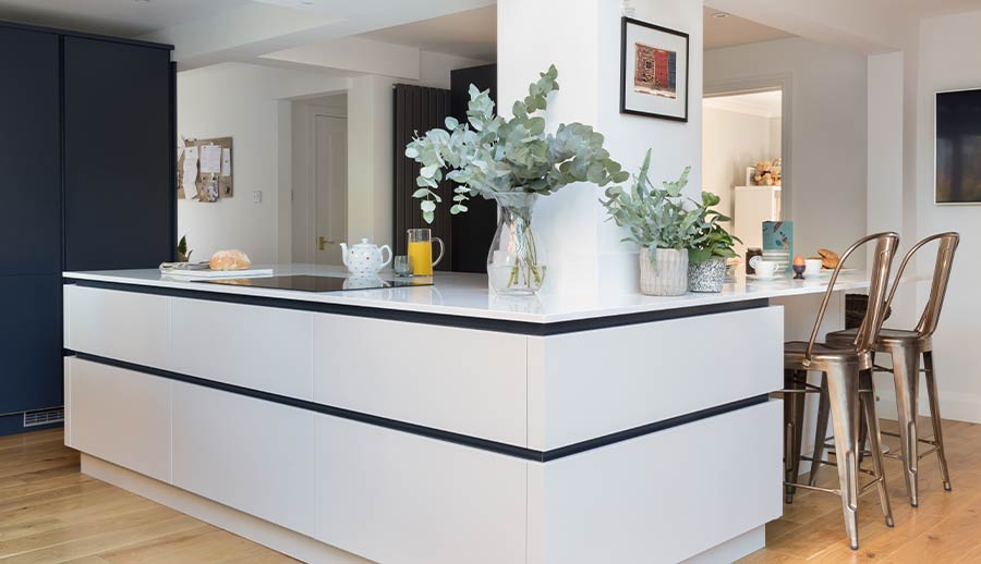 Large kitchen island in a blue handleless kitchen