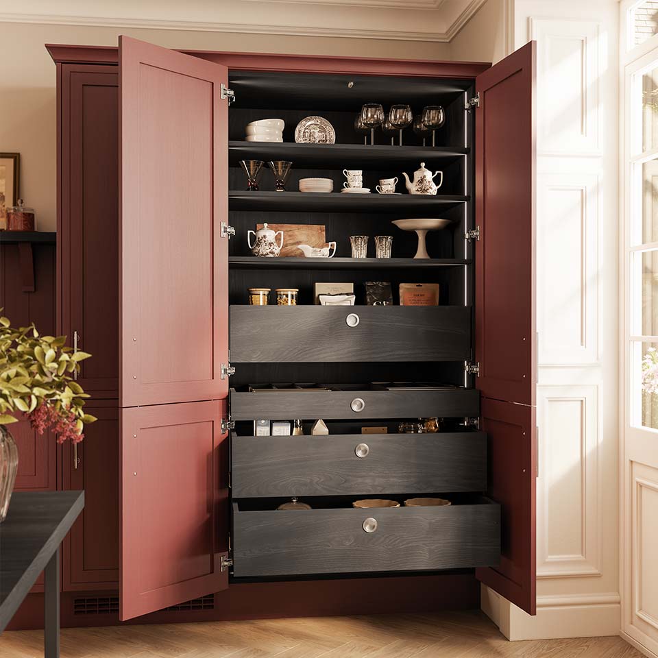 Pull-out larder unit in dark wood (Espresso) in a red kitchen