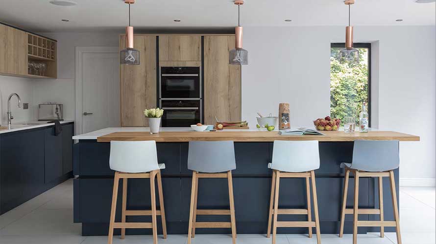 A dark blue modern kitchen with handleless doors