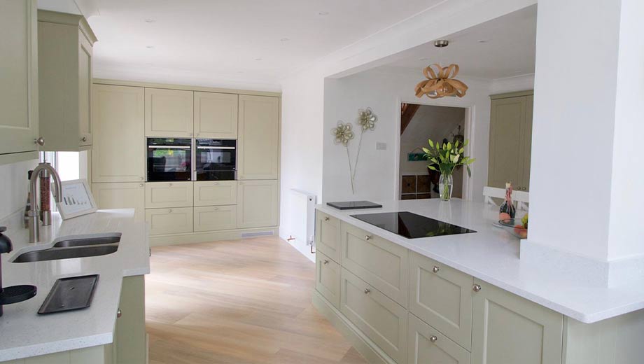 Light green kitchen with large kitchen island