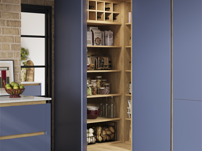 A handleless corner pantry with matching oak internals and cabinet handlerails