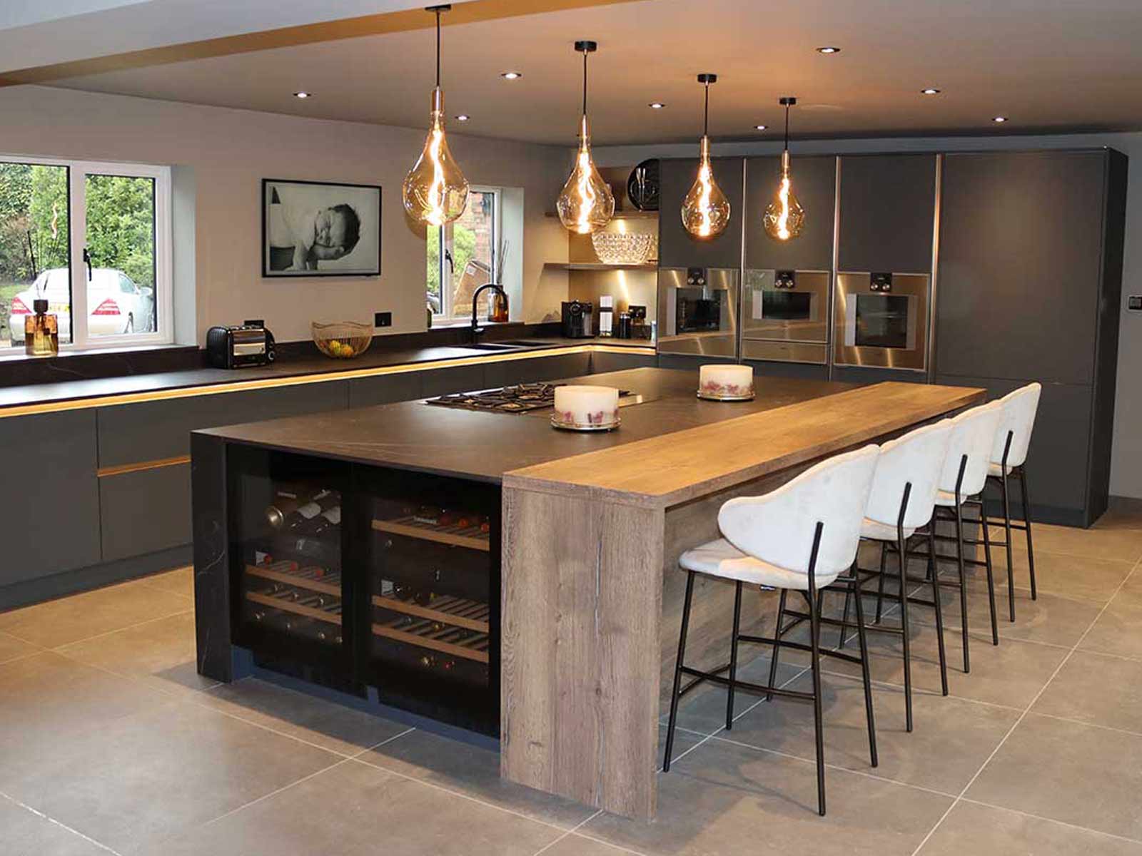 Grey kitchen with a kitchen island and bar stools