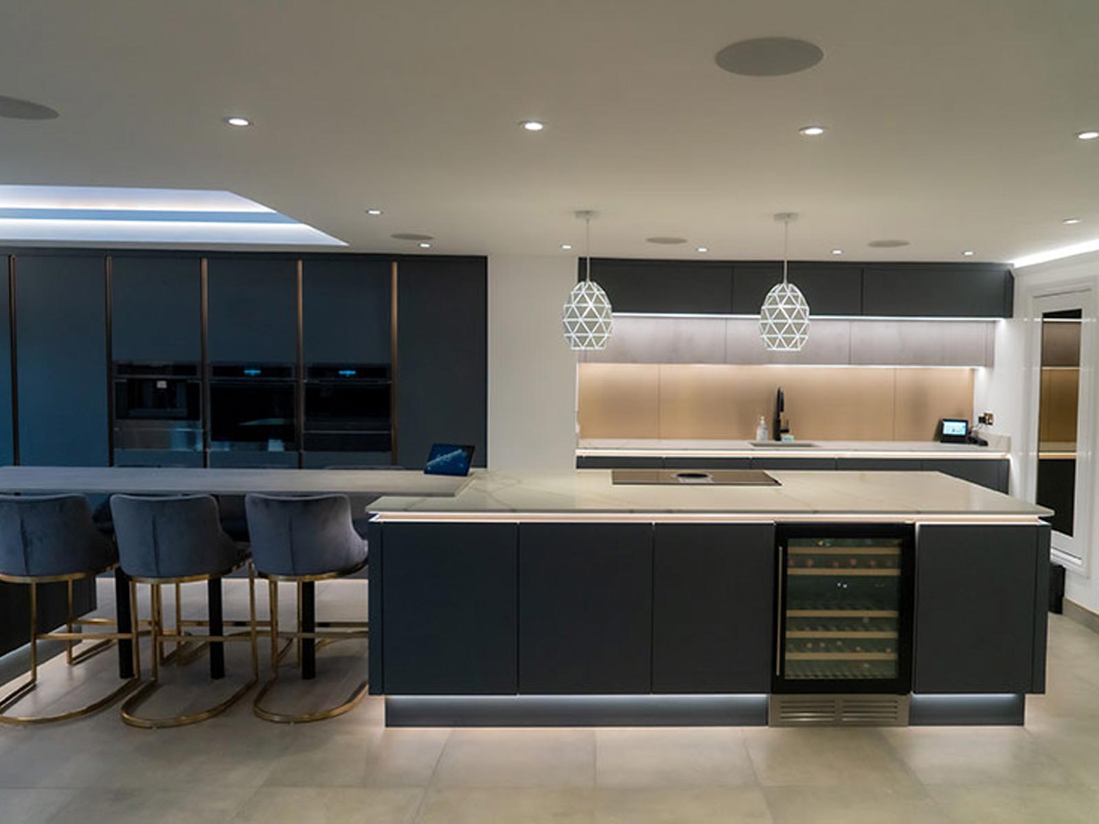 Modern home bar with pendant kitchen ceiling lights and under cabinet lighting