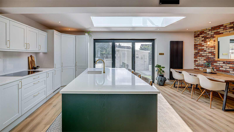 Open plan kitchen dining table and island setup in an open plan kitchen diner