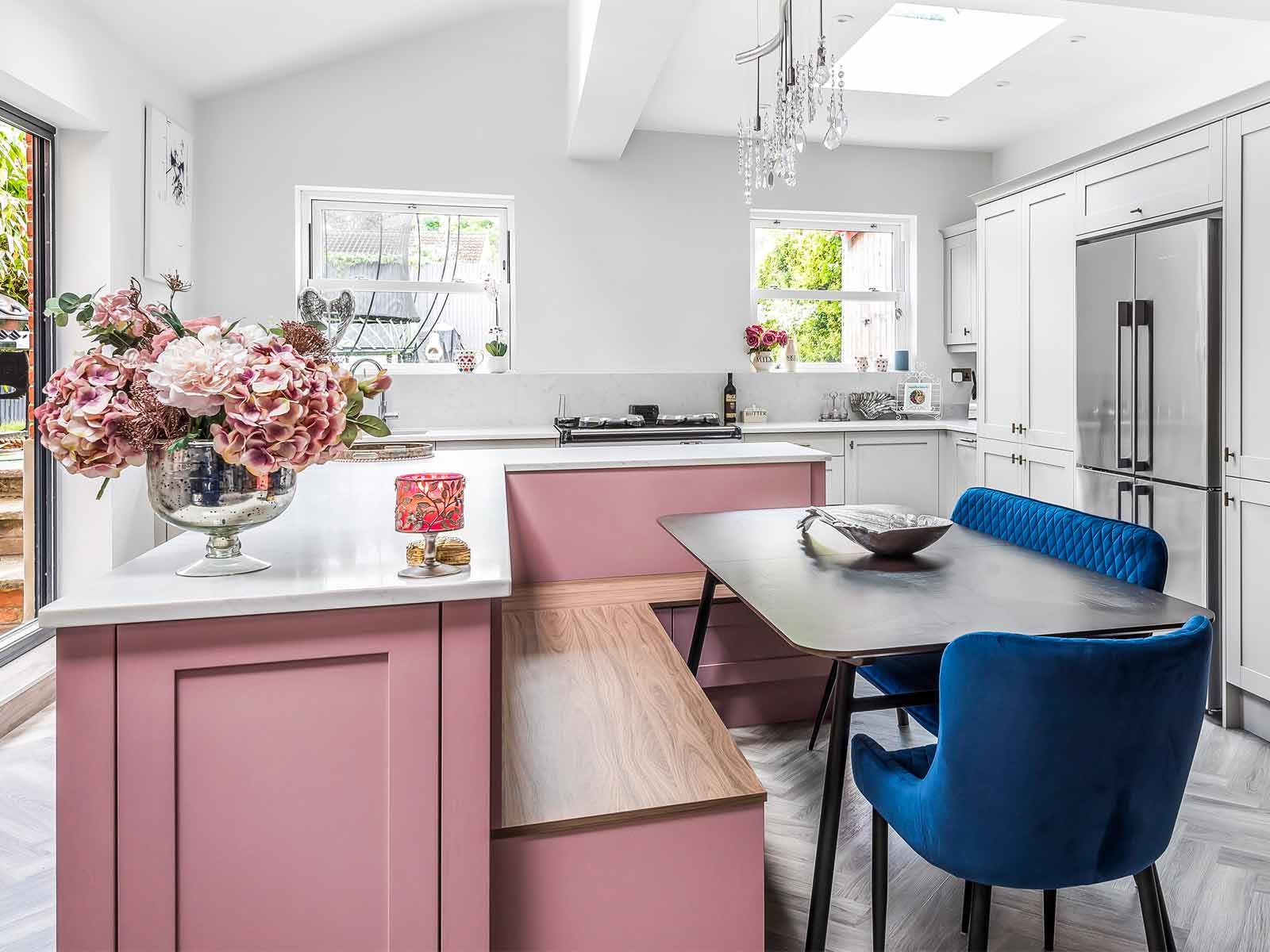 Pink kitsch kitchen cabinets with integrated seating