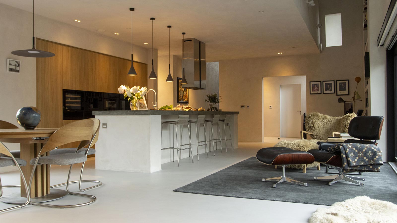 A desert modern kitchen with mid-mod dining chairs and an island