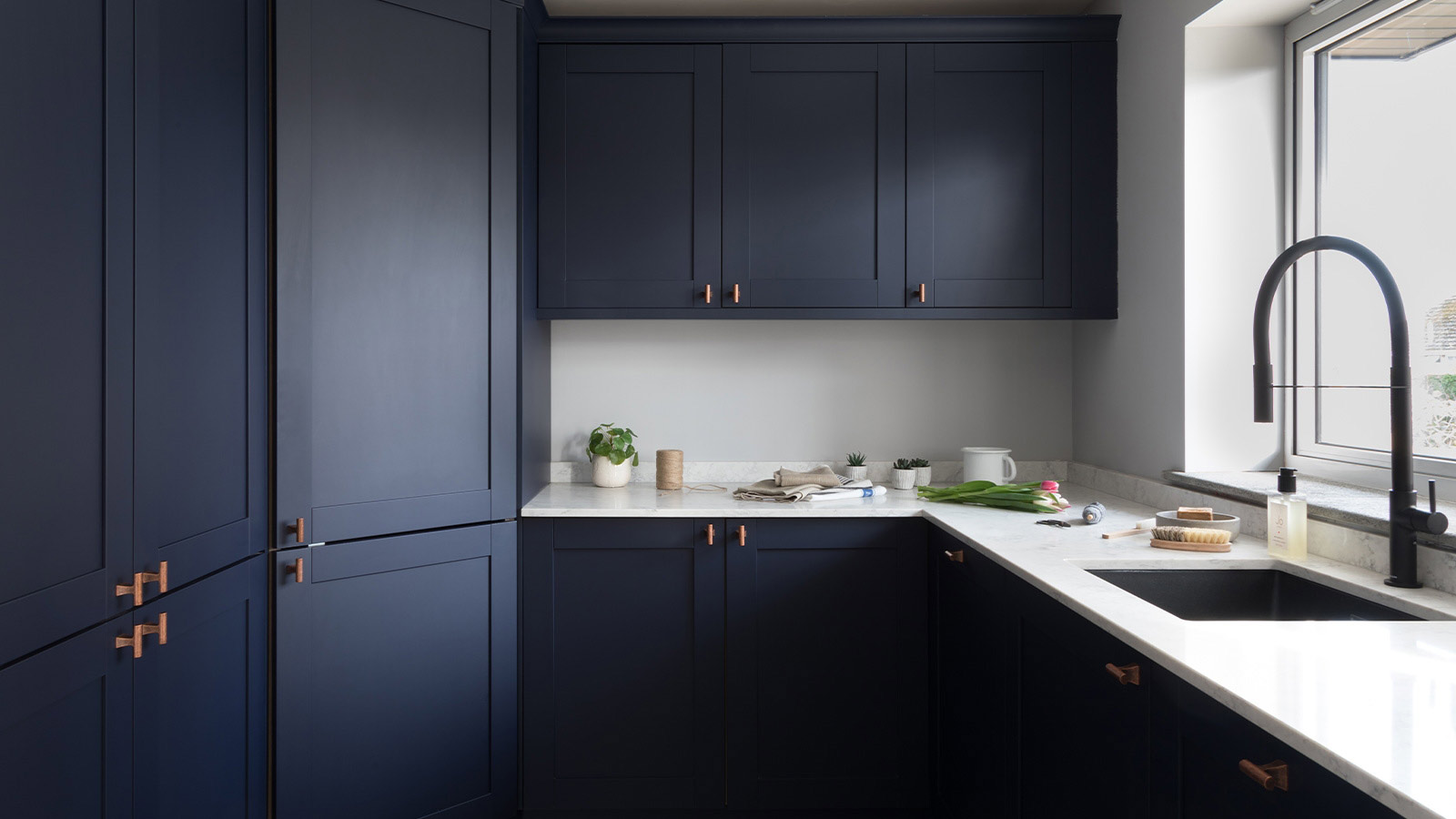 Utility room cupboards with dark blue doors