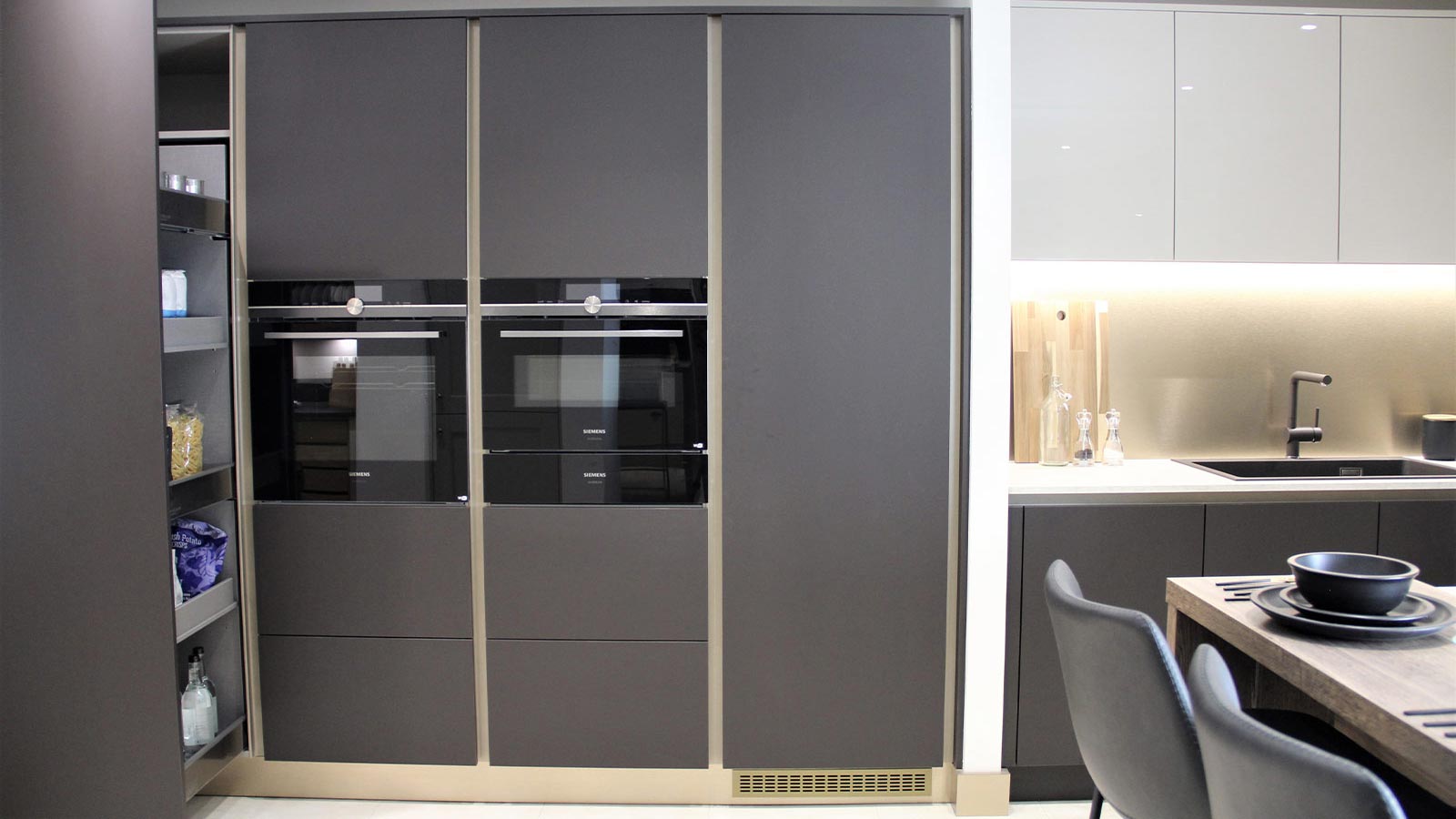 Dark cabinets and metallic handlerails in a modern luxury kitchen