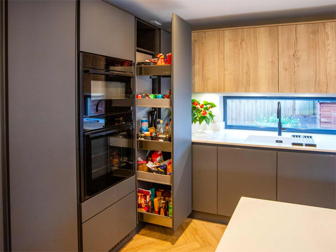 A flat slab door kitchen with modern handleless kitchen pull-out larder