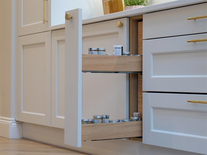 A minimalist design kitchen with a pull-out spice rack in minimalist Shaker kitchen cabinets