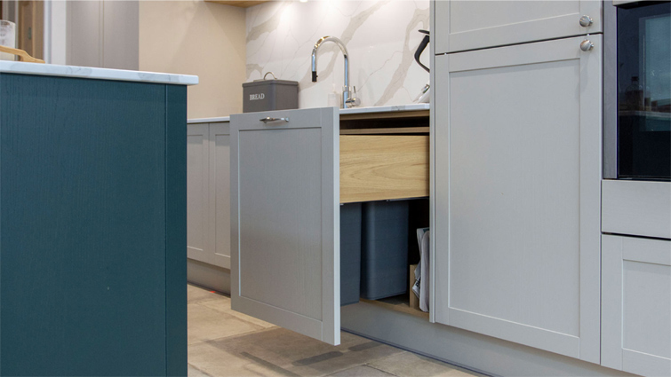 An integrated bin in a small minimalist kitchen inspired by Scandinavian minimalism