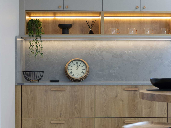 A decluttered kitchen counter with grey minimalist kitchen cabinets and a calm kitchen vibe