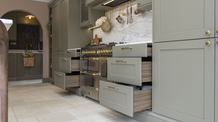 Mushroom kitchen walls around a green and walnut cabinet