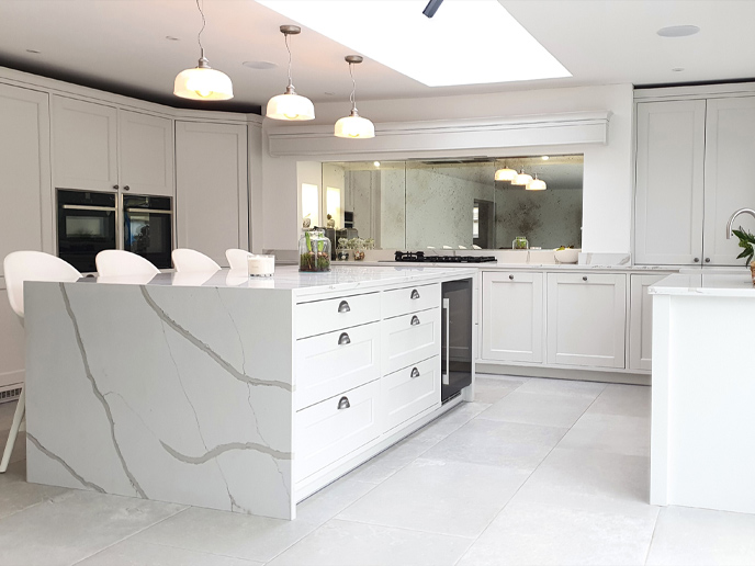 A classic grey kitchen with white marble worktops