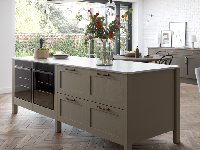 A kitchen in mushroom with matt white worktops