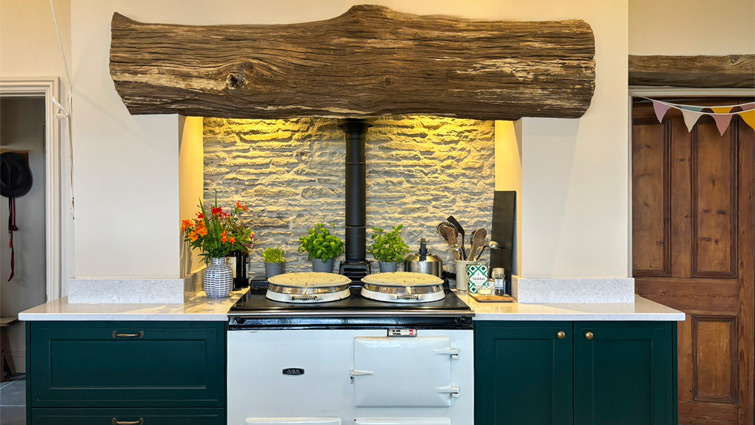 A natural earthy kitchen with dark green cabinet doors