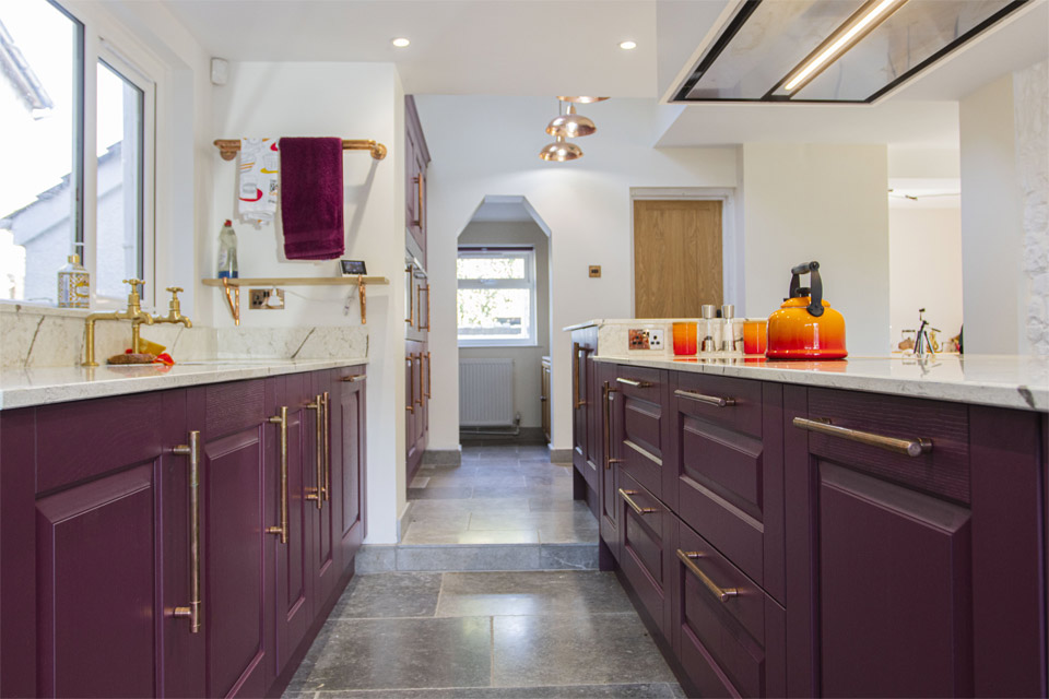 A red kitchen with burgundy kitchen cabinets