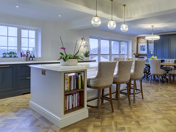 Big kitchen island with seating and in-built storage shelves