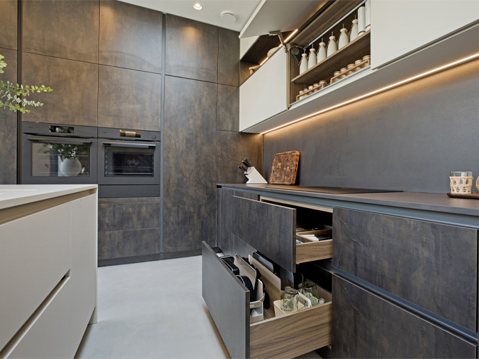 A small kitchen island, UK-made, opposite open drawers