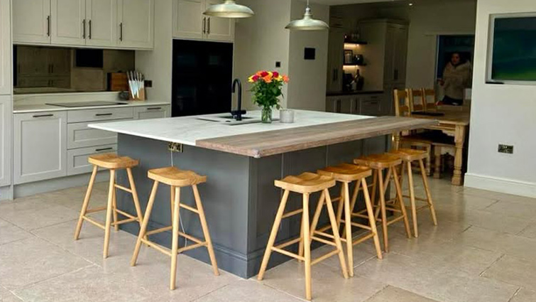 Large kitchen island in a beautiful modern kitchen with classic doors