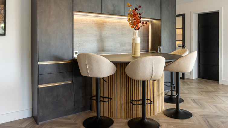 A kitchen island with seating that’s adding an island to a kitchen wall cabinet bank