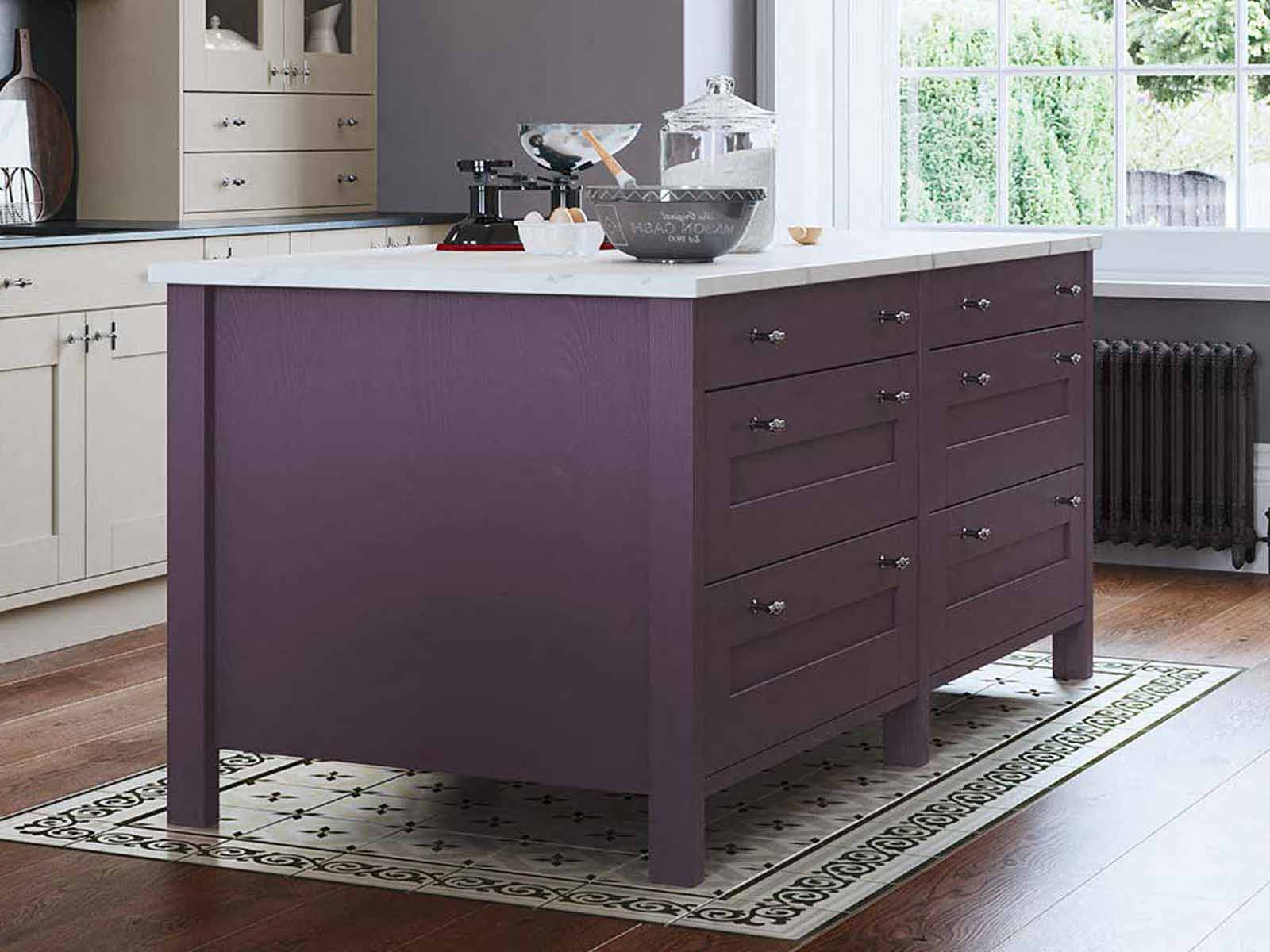 A mulberry Sherborne purple kitchen island with a while marble worktop
