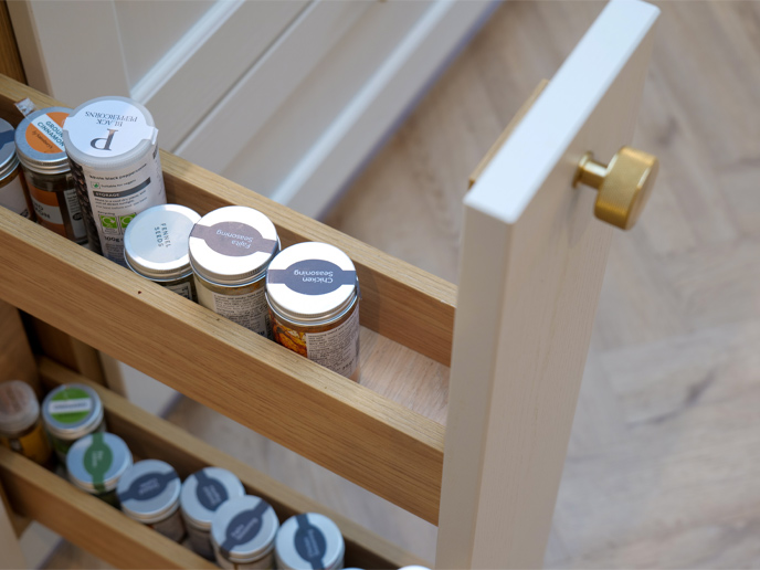 A sliding spice rack for slim cabinets with limited under-cabinet spice rack space