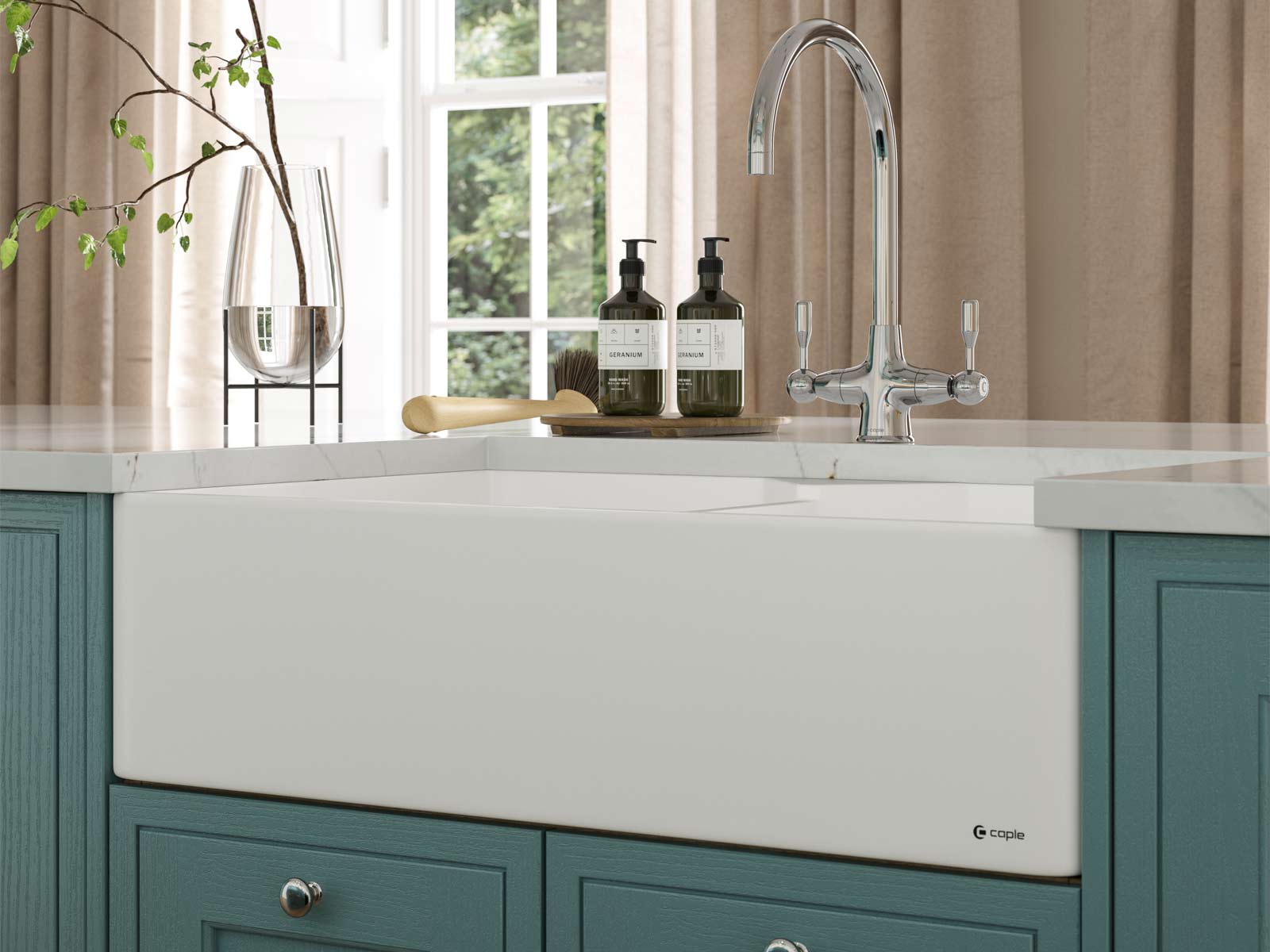 A turquoise kitchen’s white sink that complements green kitchen ideas and blue kitchen ideas
