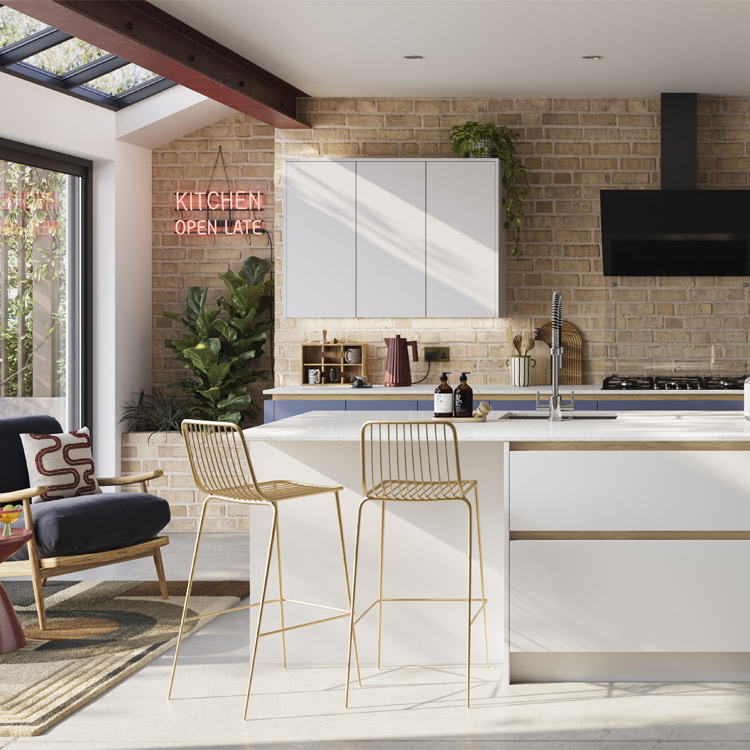 A handleless industrial kitchen with exposed brick walls