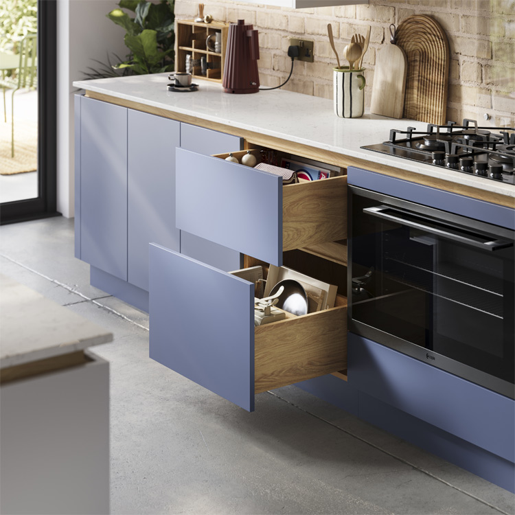 A handleless industrial kitchen featuring mid mod kitchen cabinets