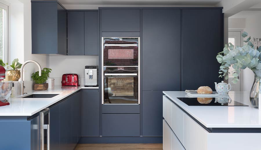 Tall kitchen storage in a blue handleless kitchen
