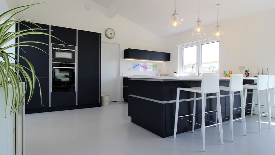 Modern dark blue kitchen with white handlerails